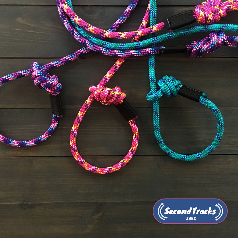 Colorful, durable (Used) Slip Leads with knots are arranged on a dark wooden surface. The leads feature pink, blue, and mystery color accents. A "Second Tracks Used" logo appears in the bottom right corner.